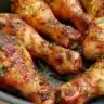 A plate of golden air fryer chicken drumsticks ready to eat in 30 minutes.
