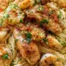 Plate of Chicken Scampi Pasta garnished with parsley and lemon
