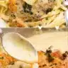 Creamy lemon chicken piccata served with fresh herbs and lemon slices