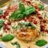 Delicious creamy Parmesan Basil Chicken served on a plate with basil garnish