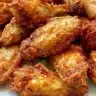 Crispy air fryer chicken wings garnished with herbs