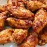 Crispy air fryer chicken wings served on a platter with dipping sauce