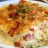 Delicious Easy Keto Chicken Cordon Bleu Casserole topped with cheese and herbs