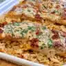 Plate of high protein creamy Cajun chicken and rice garnished with herbs