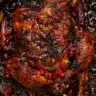Cranberry Maple Roast Chicken served with fresh herbs and seasonal garnishes